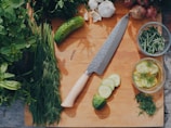 sliced cucumber and green vegetable on brown wooden table