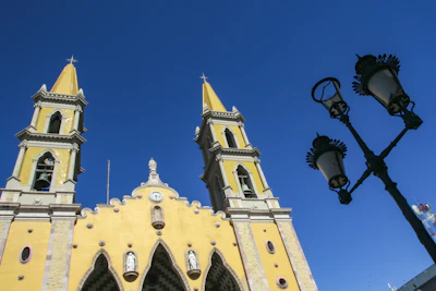The yellow towers of the cathedral against a blue sky in Mazatlán