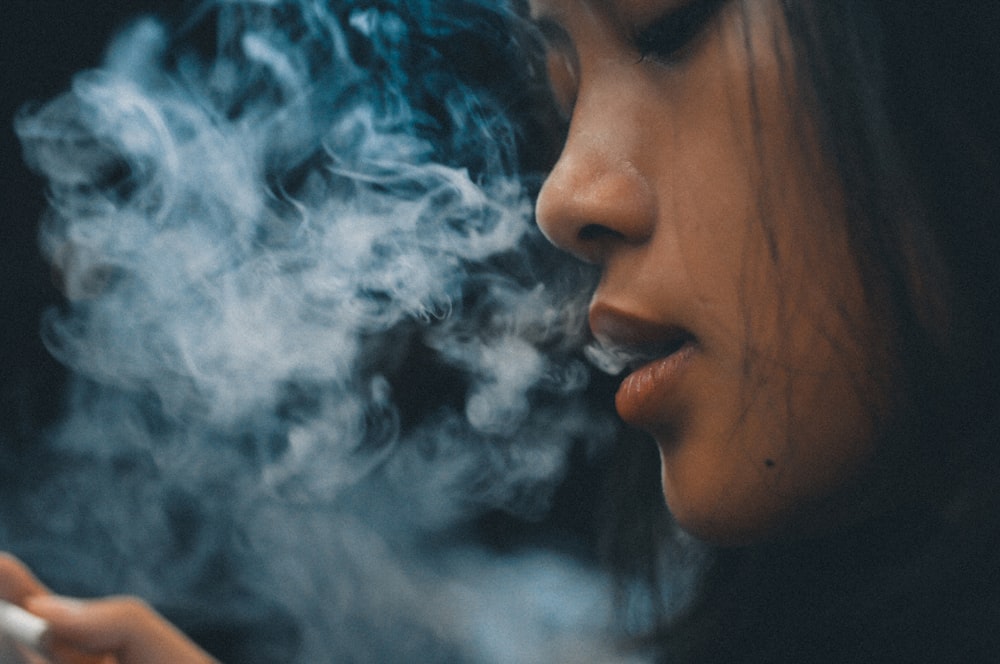 woman with blue and white smoke