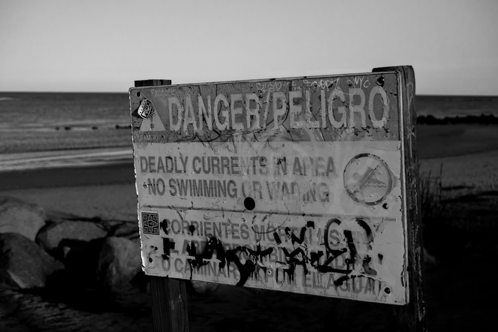 grayscale photo of white and black wooden signage