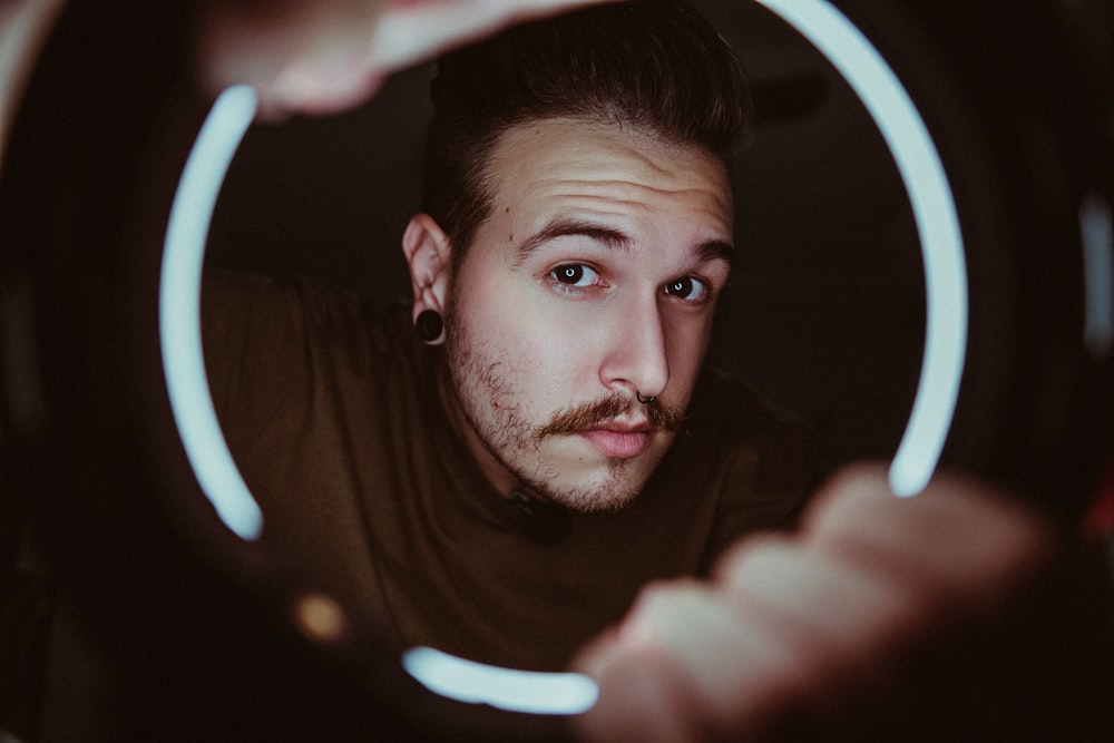 man in black shirt holding white light