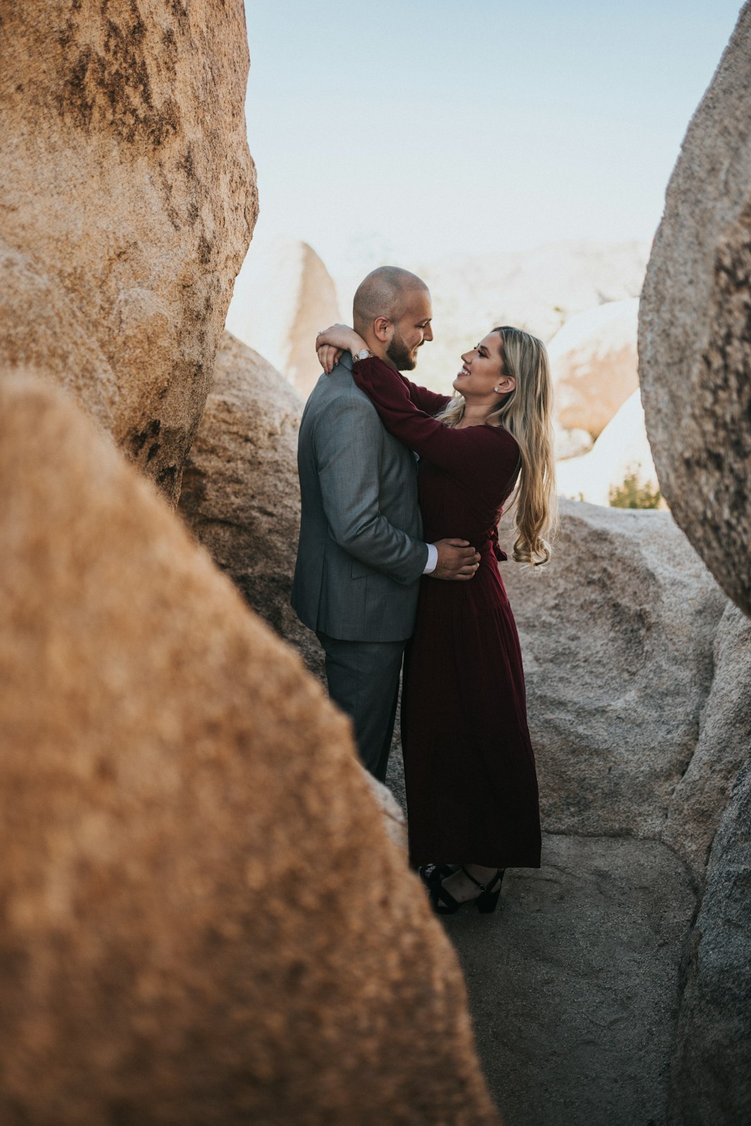 man and woman standing on rock formation during daytime