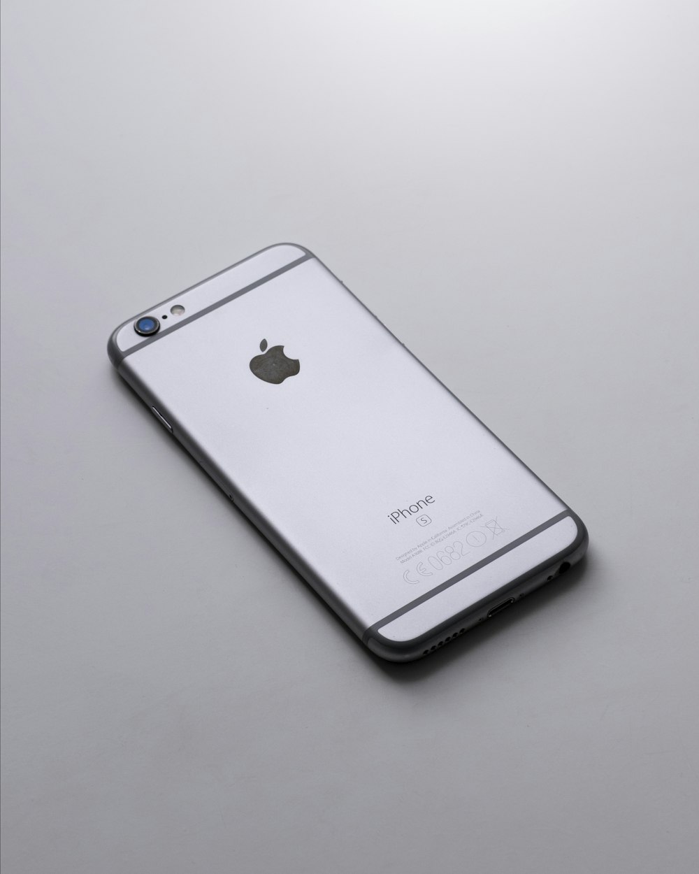 silver iphone 6 on white table