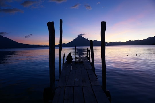 brown wooden dock on sea during daytime in Lake Atitlán Guatemala