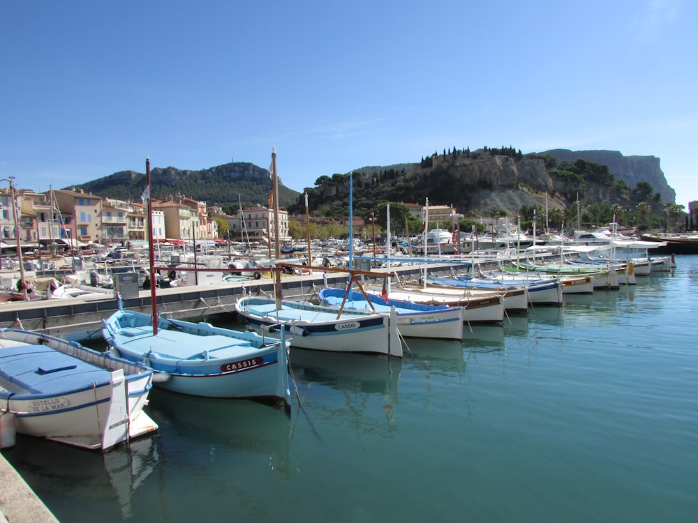 white and blue boats on sea during daytime