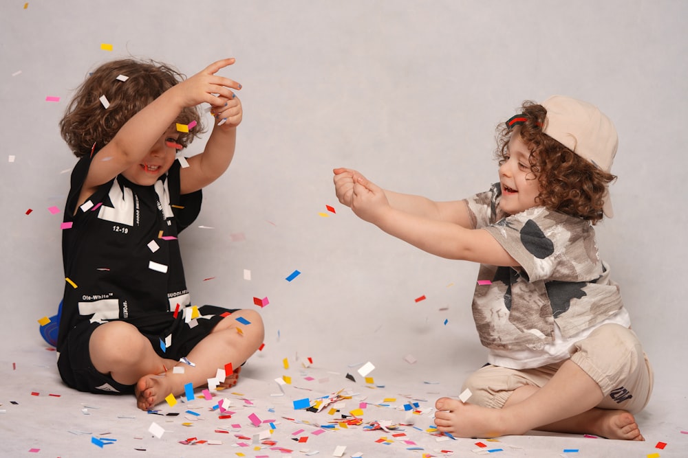 girl in black and white shirt playing with girl in white shirt