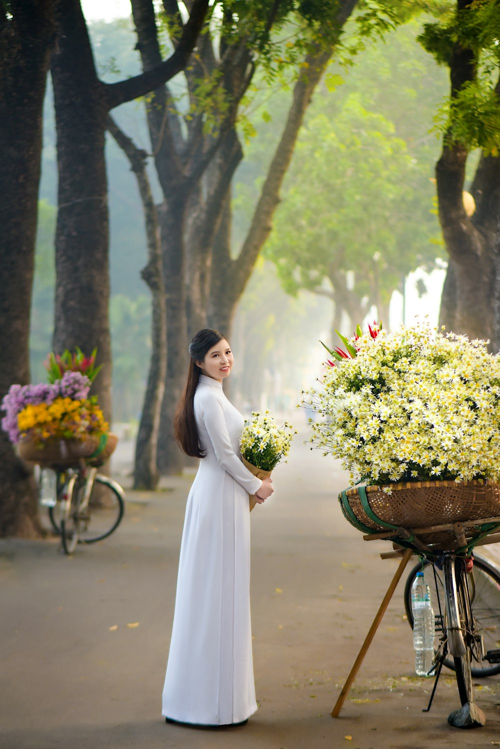 woman in white wedding dress holding bouquet of flowers