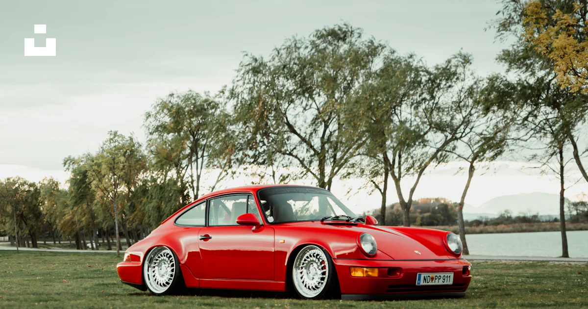 Red Porsche 911 On Green Grass Field During Daytime Photo Free Car red-porsche-911-on-green-grass-field-during-daytime-photo-free-car