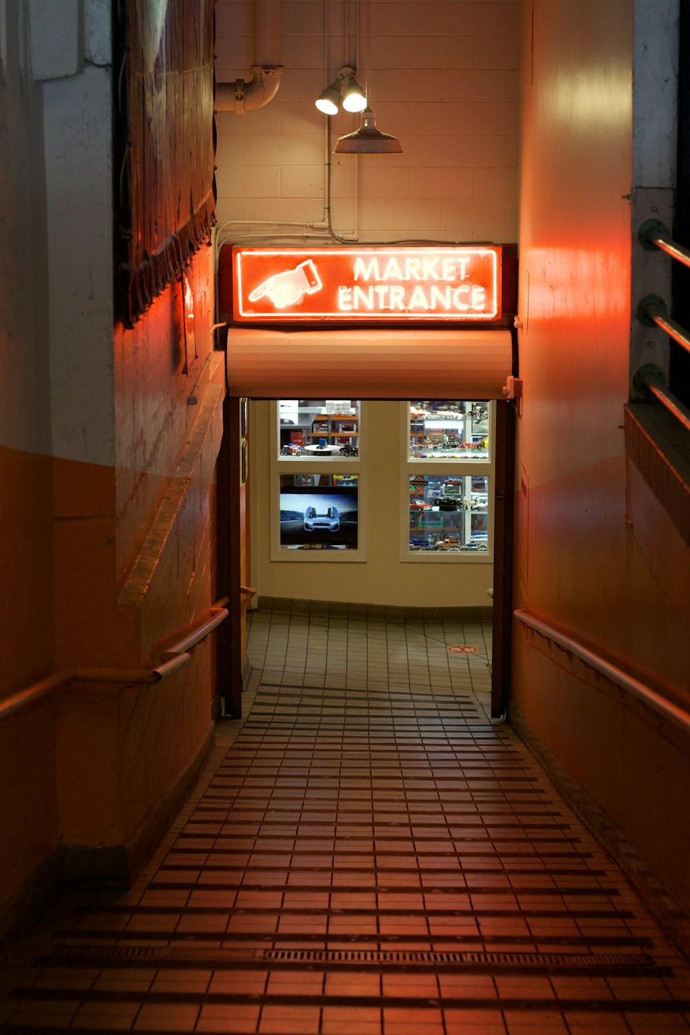 a long hallway leading to a market entrance