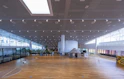 A spacious indoor venue featuring polished wooden floors and large windows letting in natural light.
