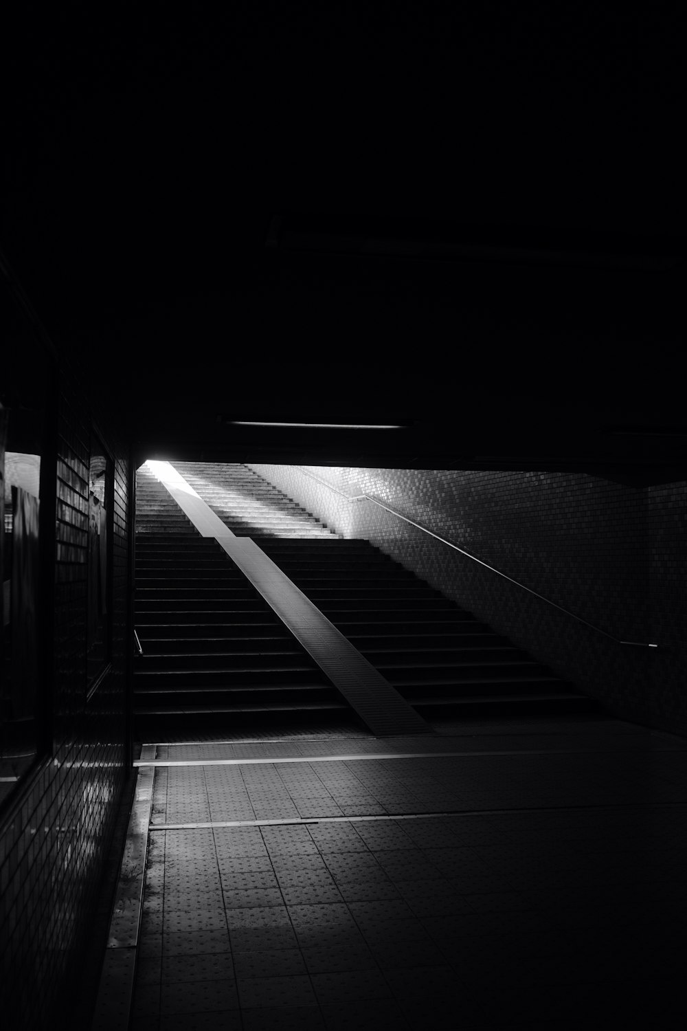 grayscale photo of empty tunnel