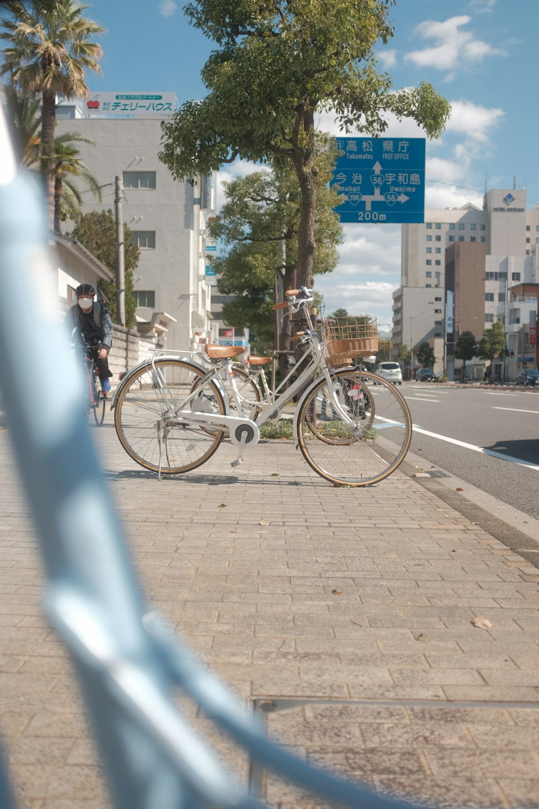 black city bike parked on sidewalk during daytime