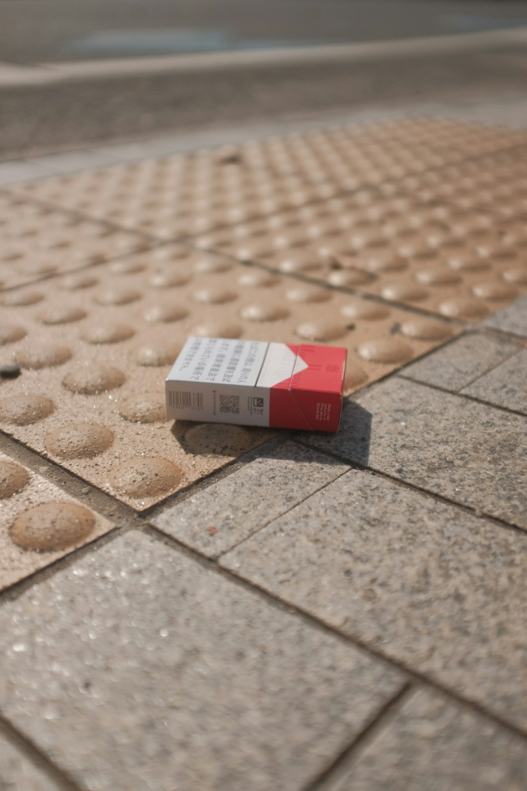 red and white marlboro cigarette pack on brown and white ceramic tiles