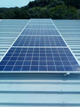 Solar panels installed on a residential roof under clear sky.