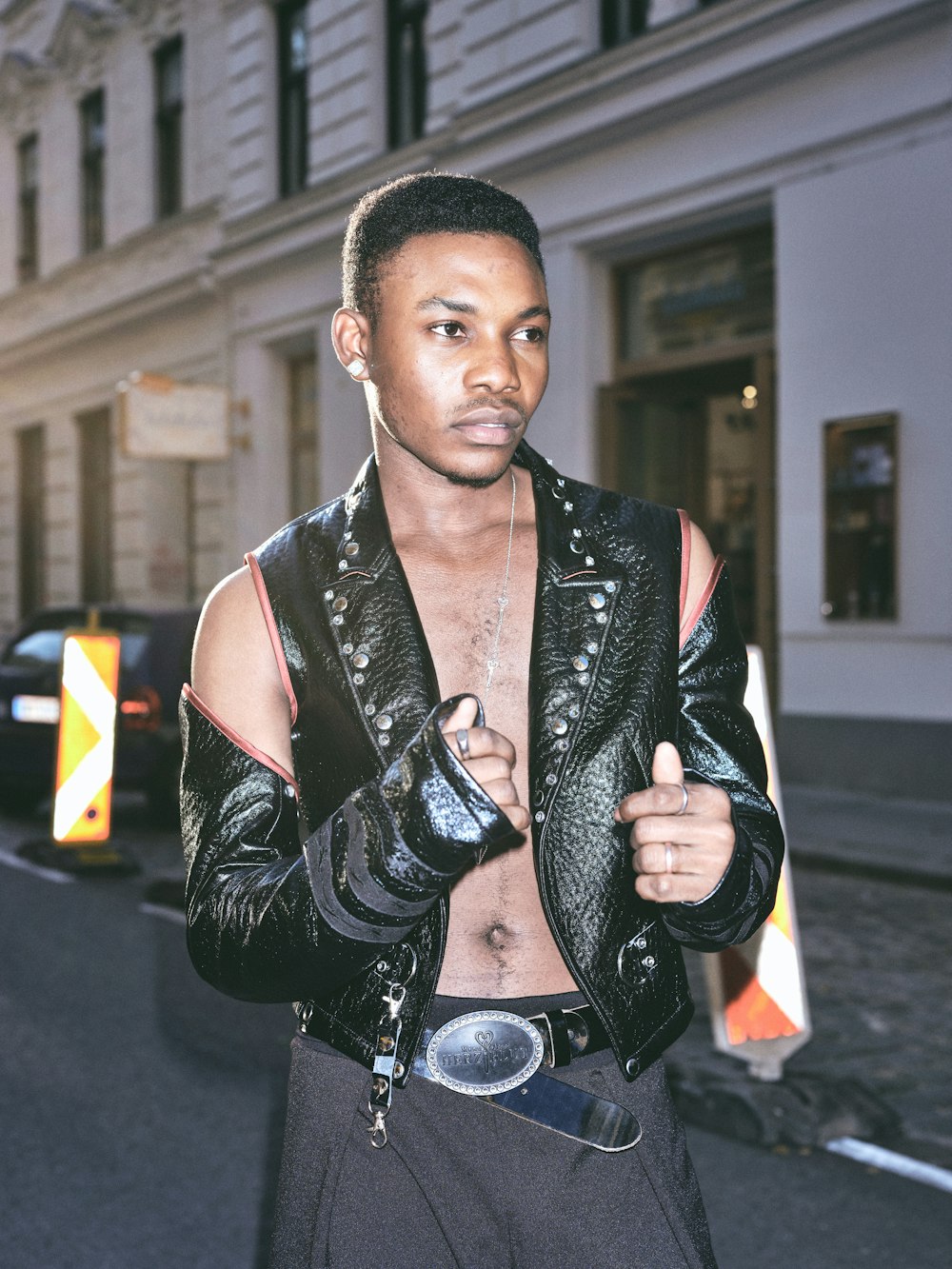 man in black leather jacket and black leather belt