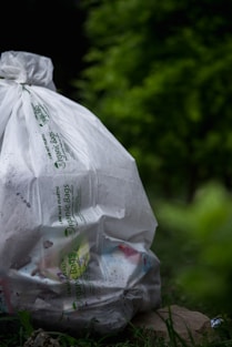 A close-up of biodegradable trash bags displayed in a natural setting, highlighting their eco-friendly features.