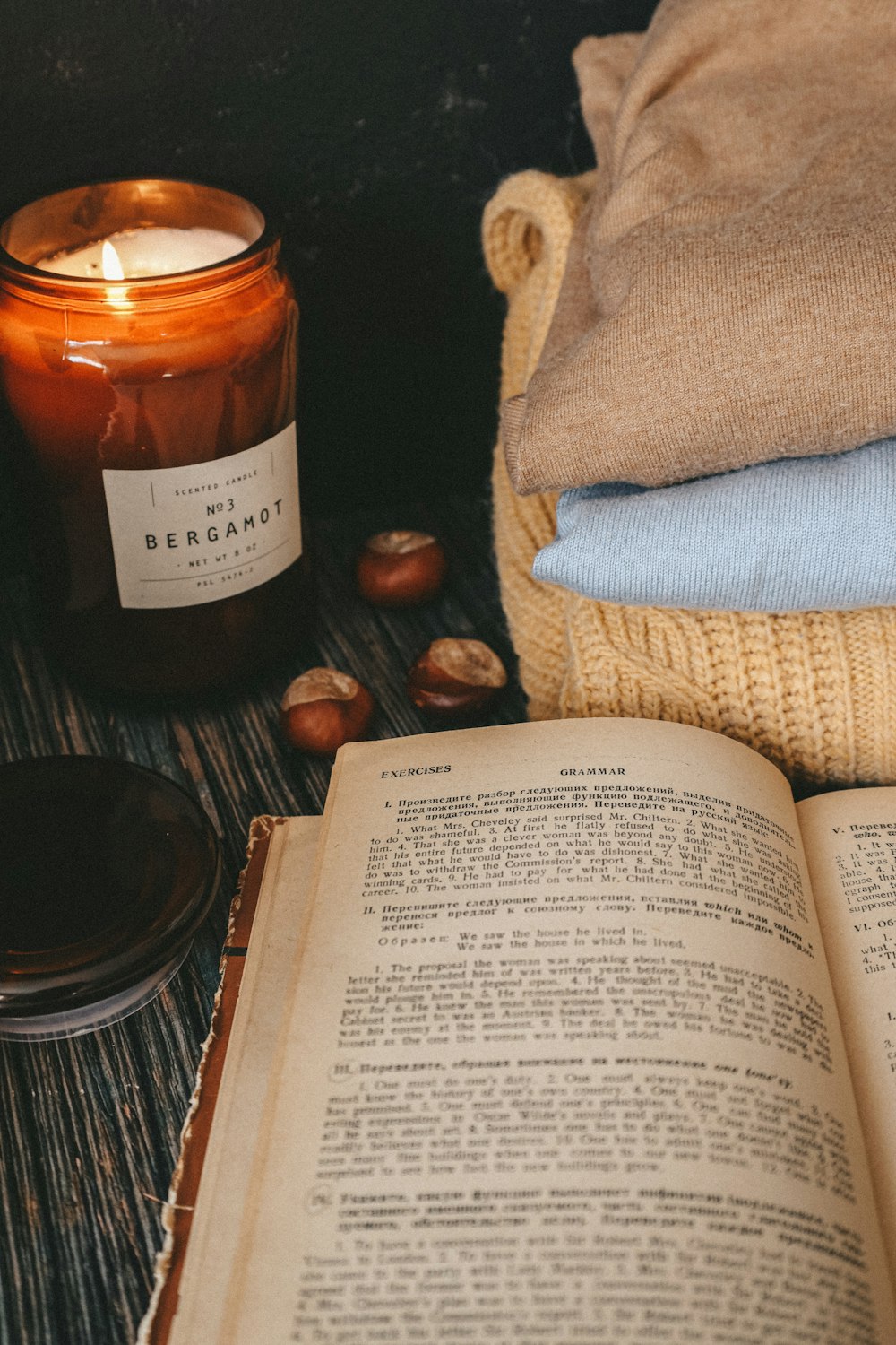 white book page beside clear glass candle holder