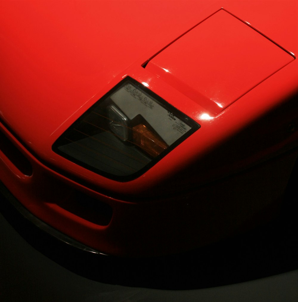 red ferrari car in close up photography