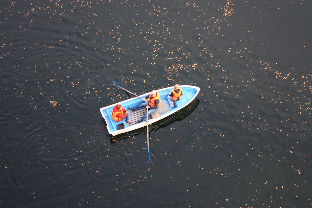 person in white and red kayak on body of water during daytime