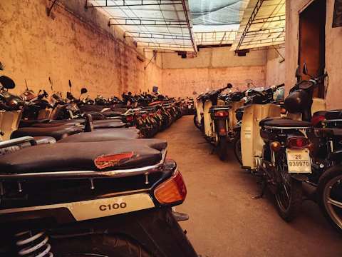 Organized rows of motorcycles inside the warehouse with clear signage and lighting.