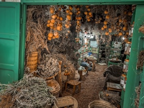 Sheikh Asuman preparing traditional herbs in a calm, sunlit room.