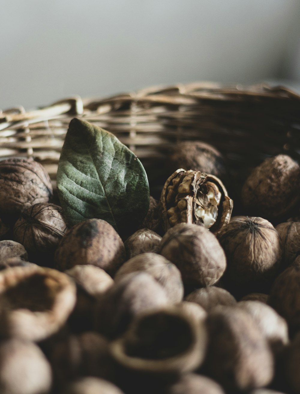 brown and green leaves on brown woven basket