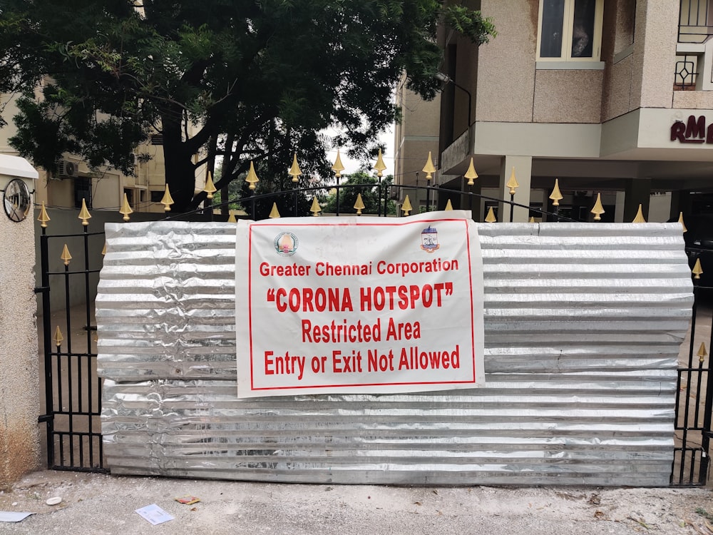 white and red signage on gray concrete wall