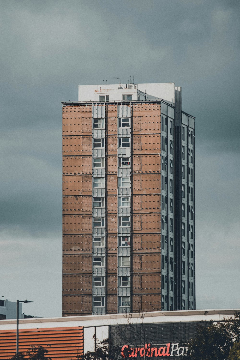 brown concrete building under gray sky