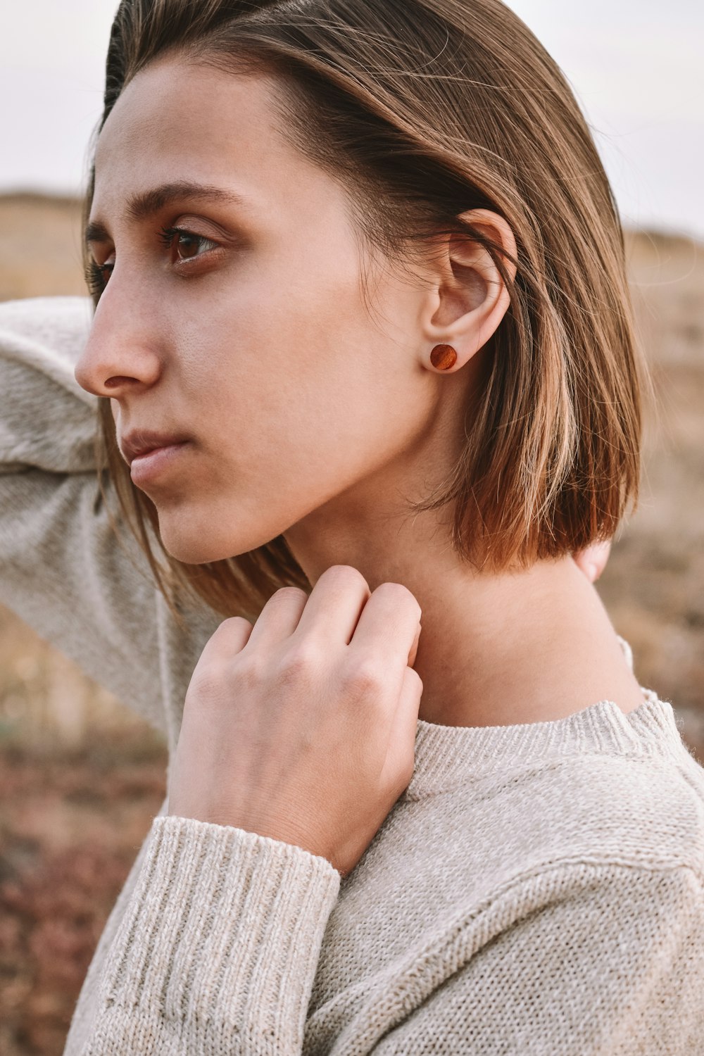 woman in gray sweater with brown hair