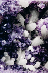 Shimmering amethyst crystals clustered together, glowing softly under natural light.