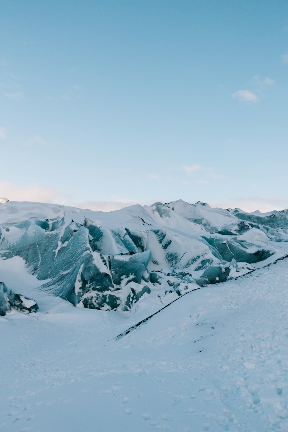 snow covered mountain under cloudy sky during daytime