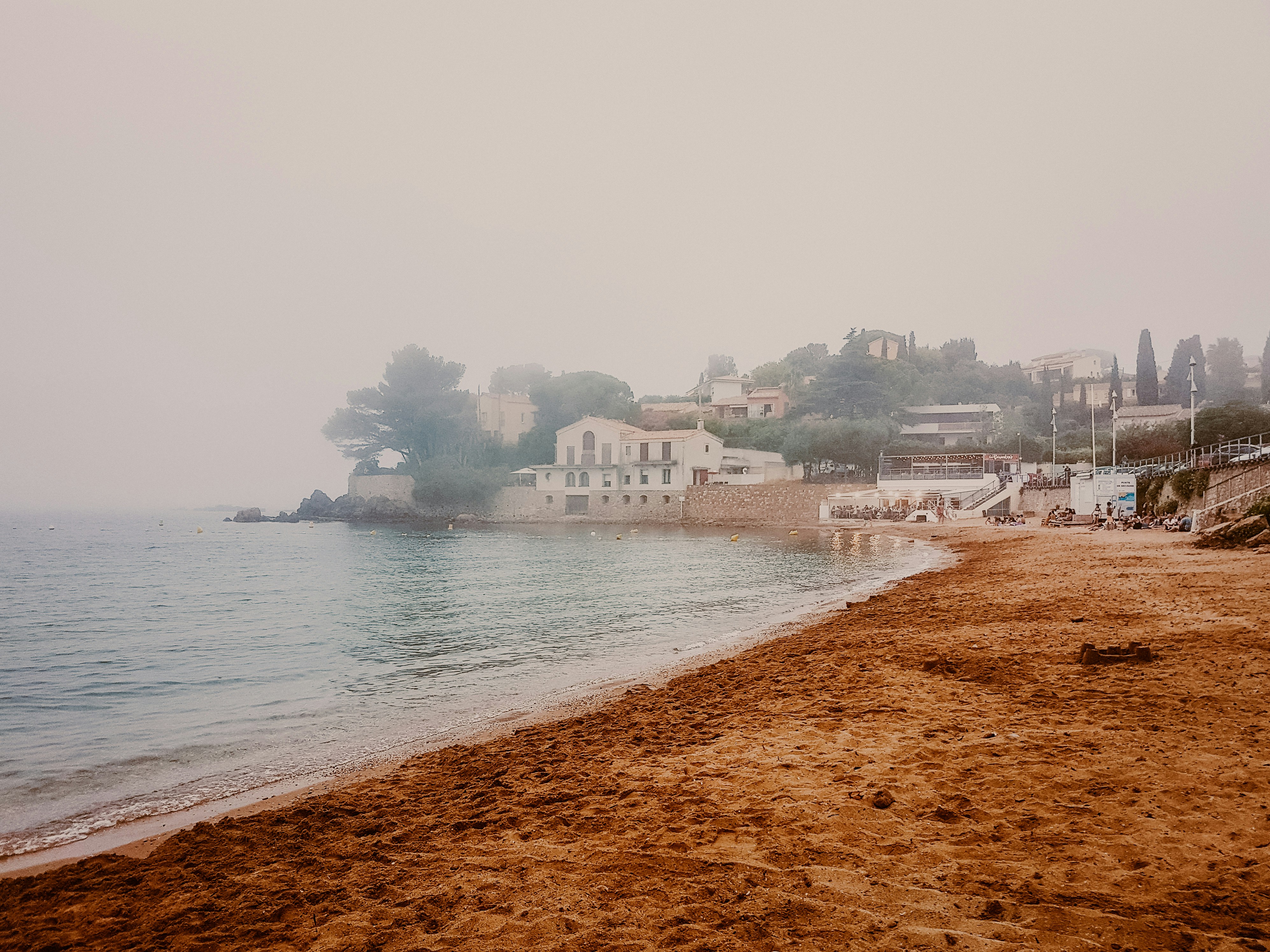 white concrete building near body of water during daytime