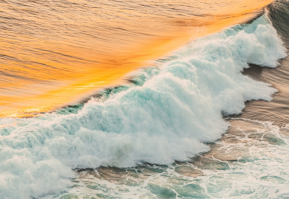 ocean waves crashing on shore during daytime