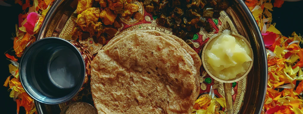 A vibrant platter showcasing colorful vegetarian dishes including paneer tikka, masala dosa, and vegetable fried rice on elegant ceramic plates.