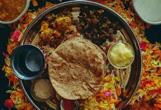 A vibrant platter showcasing colorful vegetarian dishes including paneer tikka, masala dosa, and vegetable fried rice on elegant ceramic plates.