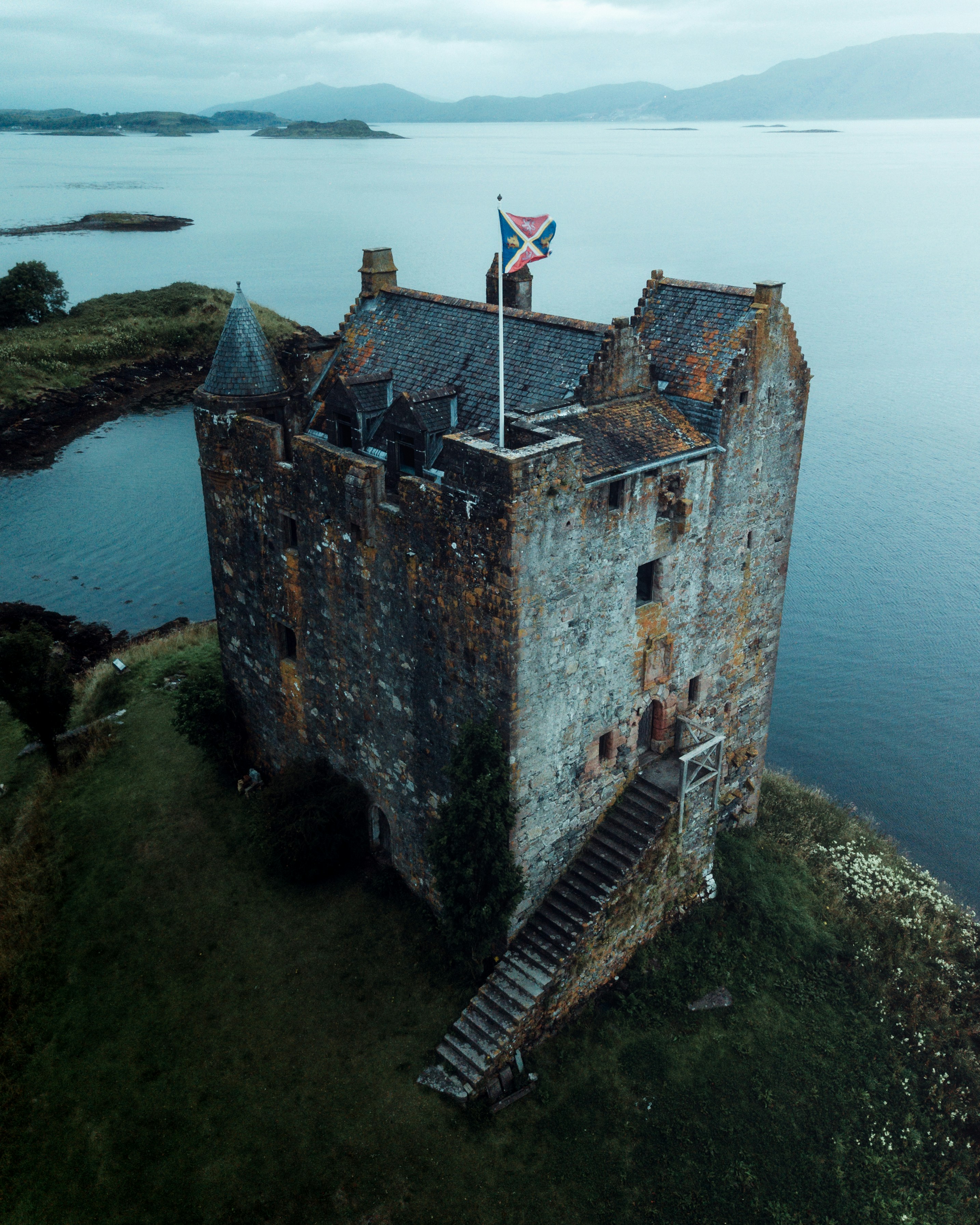 brown concrete building near body of water during daytime