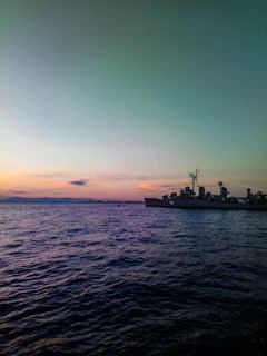 A serene sunset over calm ocean waters, reflecting the quiet strength of a naval journey.