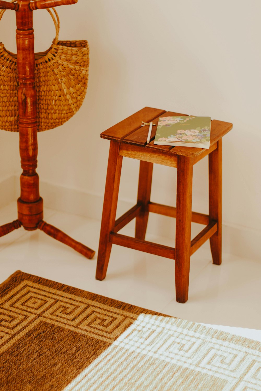 brown wooden table with white and green book on top