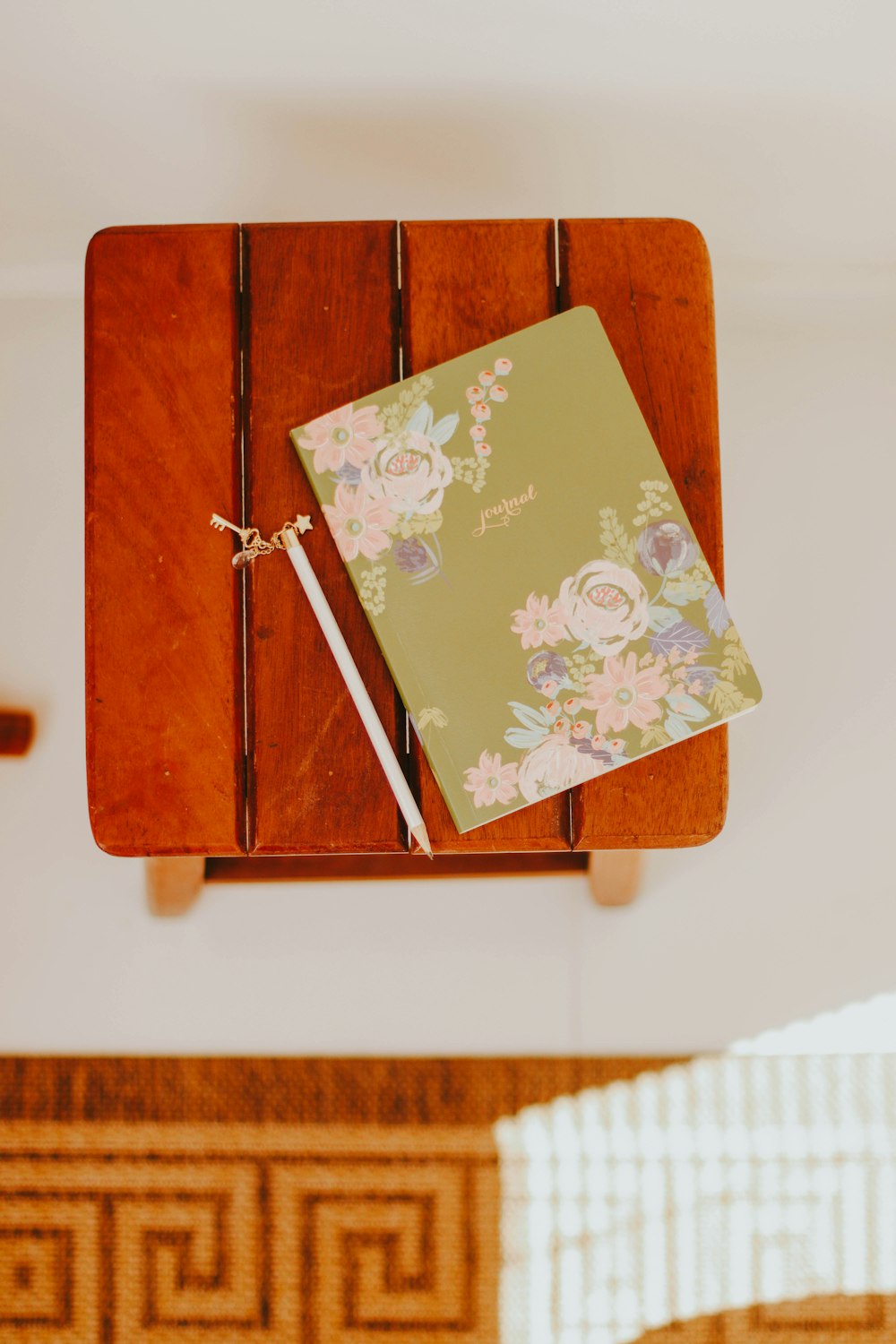 brown and white floral card on brown wooden table