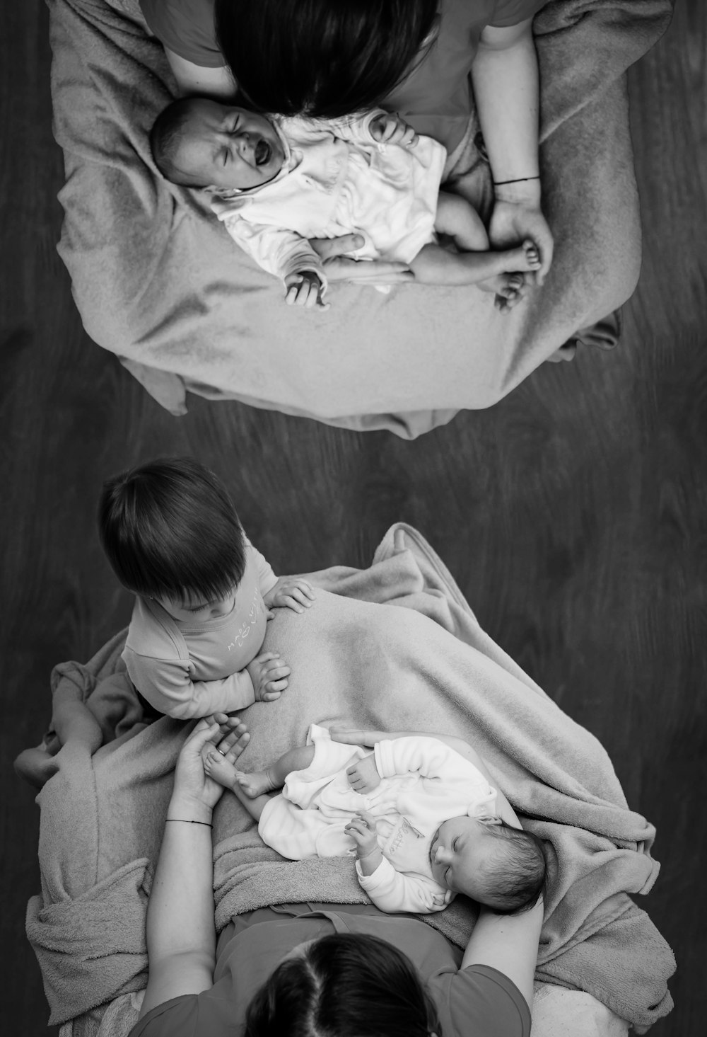 grayscale photo of woman carrying baby