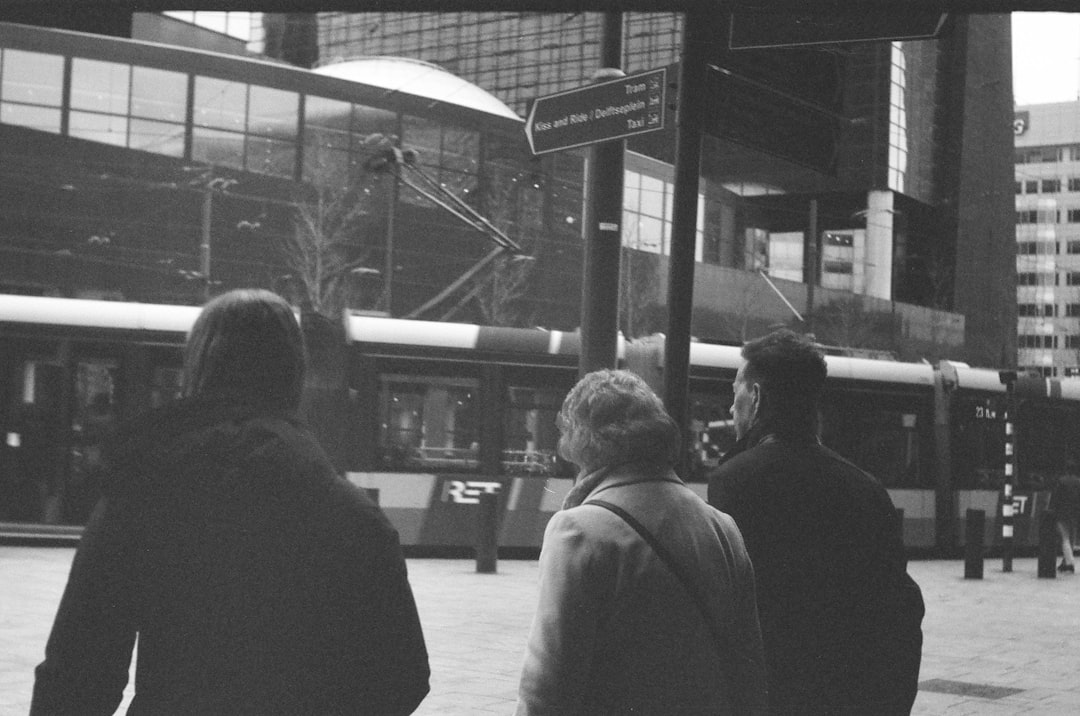 grayscale photo of people walking on sidewalk