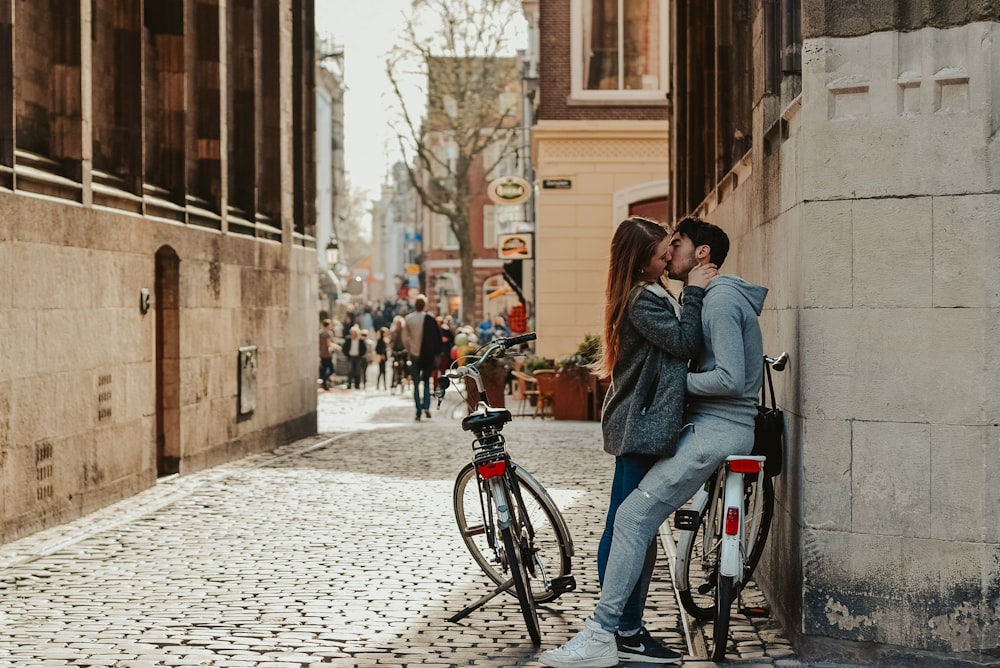 woman in blue denim jacket and blue denim jeans riding on black bicycle during daytime