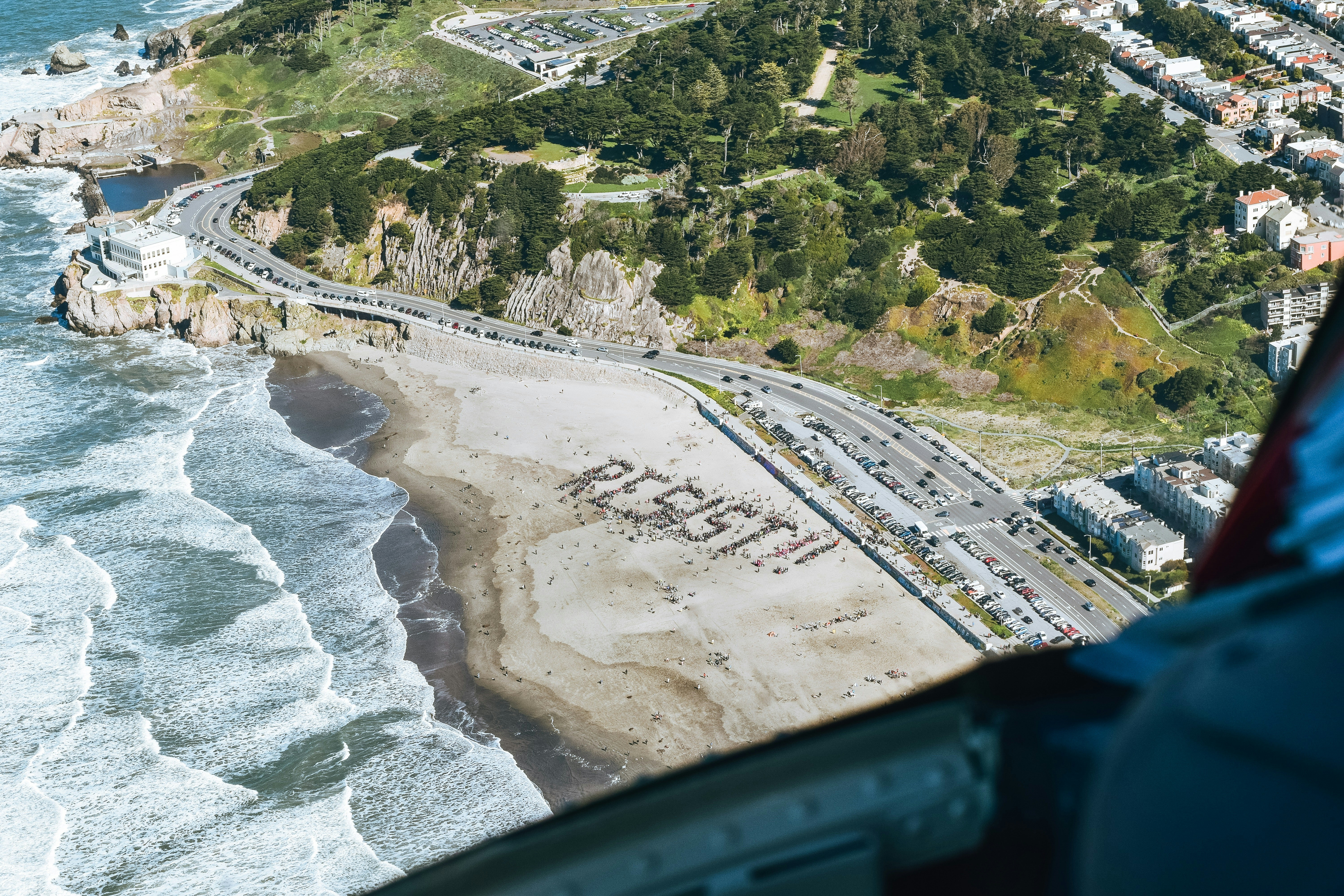 aerial view of city buildings near body of water during daytime