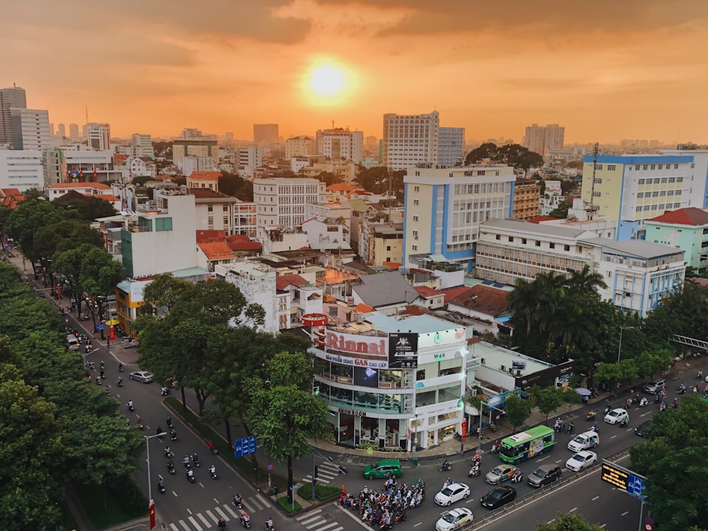 cars on road near buildings during sunset