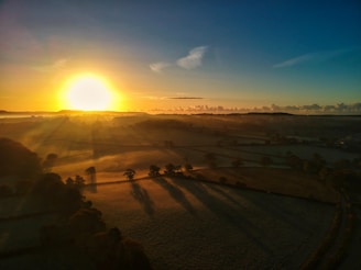 A wide-angle shot of a serene landscape with soft morning light.