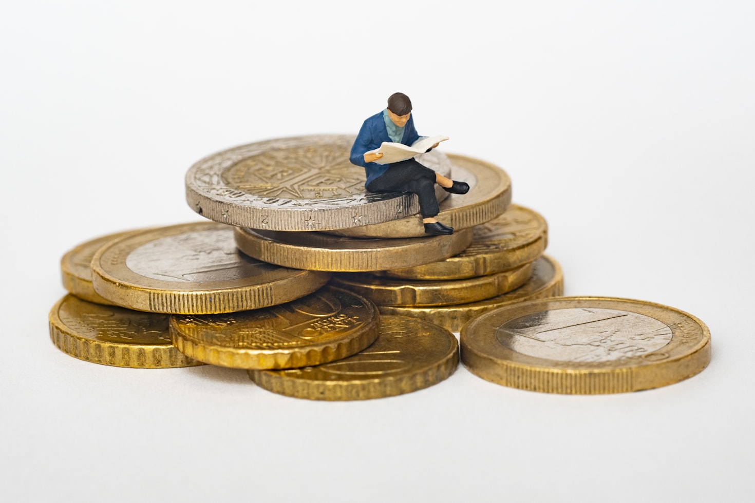 man sitting on coins pensively