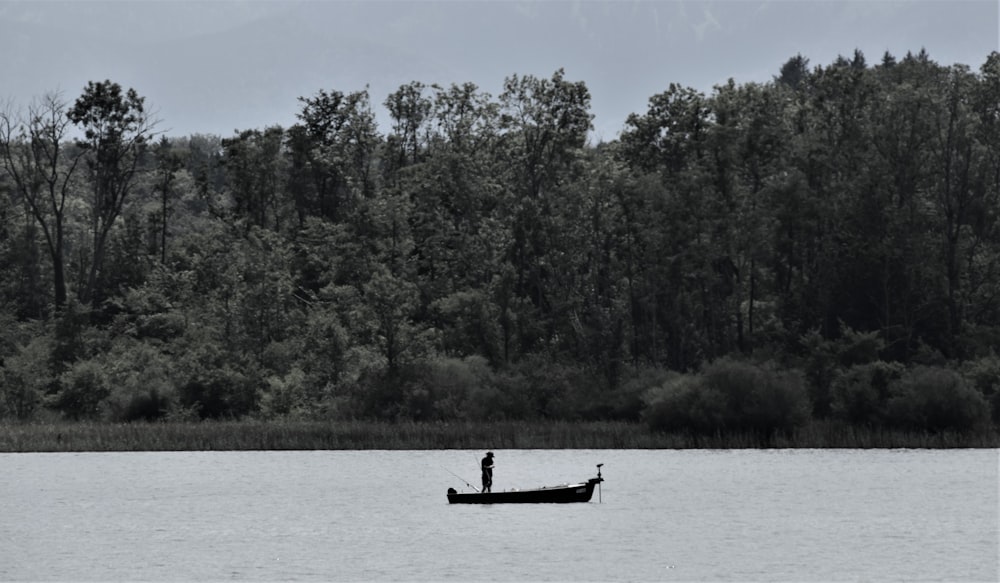 person riding on boat on lake during daytime