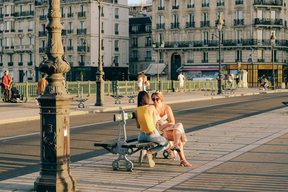 woman in white tank top sitting on bench