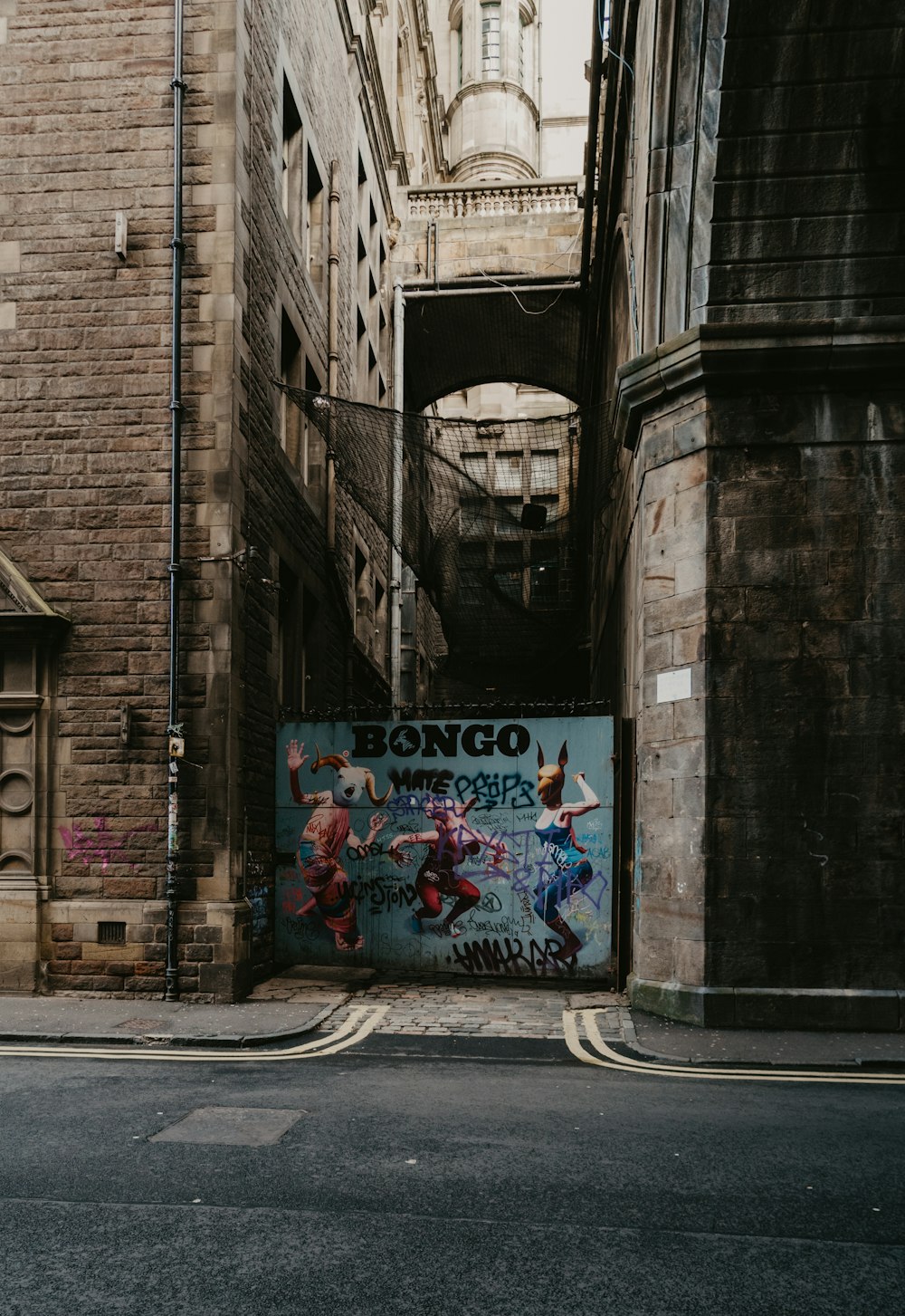 graffiti on brown brick building during daytime