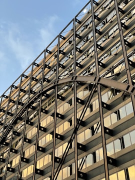 A completed modern industrial building with metallic gold accents gleaming under sunlight.